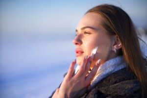 A woman applying a thick moisturizer for dry skin in winter in Frisco, TX